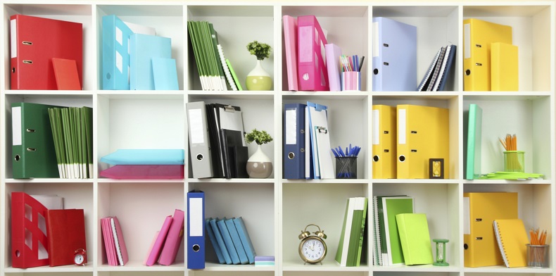 White office shelves with different stationery, close up